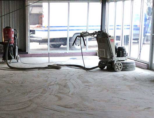 Concrete floor preparation involved both stripping and grinding the floor to a smooth finish.